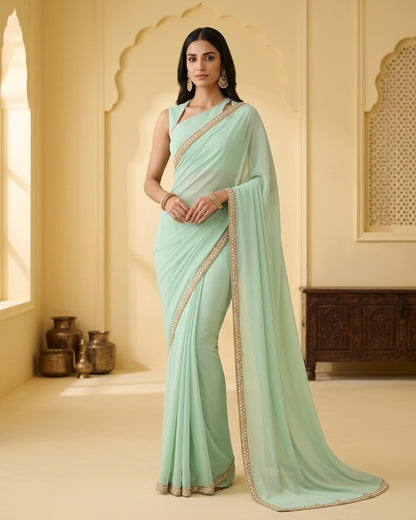 Dhriti: Dusty Mint Green Heavy Georgette Saree with Golden Lace