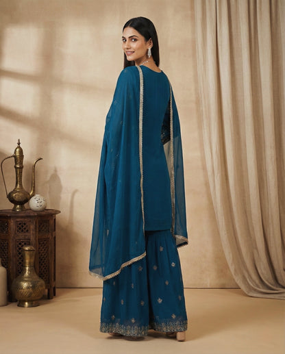 Aarohi: Teal Blue Embroidered Sharara Set by Velltiska