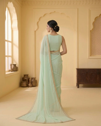 Dhriti: Dusty Mint Green Heavy Georgette Saree with Golden Lace