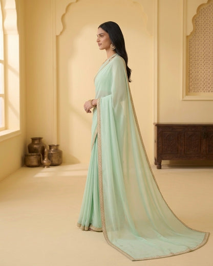 Dhriti: Dusty Mint Green Heavy Georgette Saree with Golden Lace