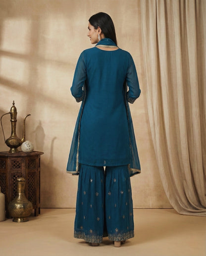 Aarohi: Teal Blue Embroidered Sharara Set by Velltiska