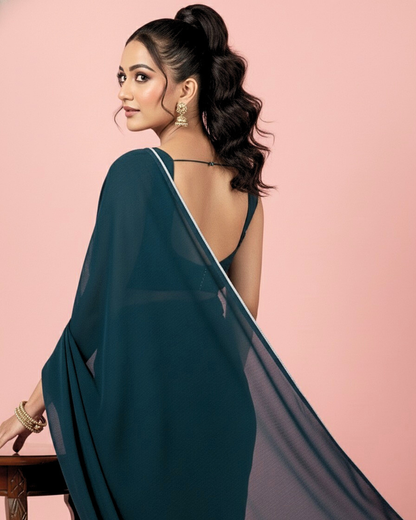 Neelkamal: Teal Blue Heavy Georgette Saree with White Piping